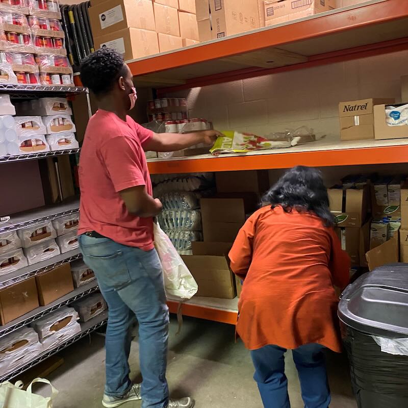 Food and nutrition volunteer help organize the pantry at Nashville Cares. 